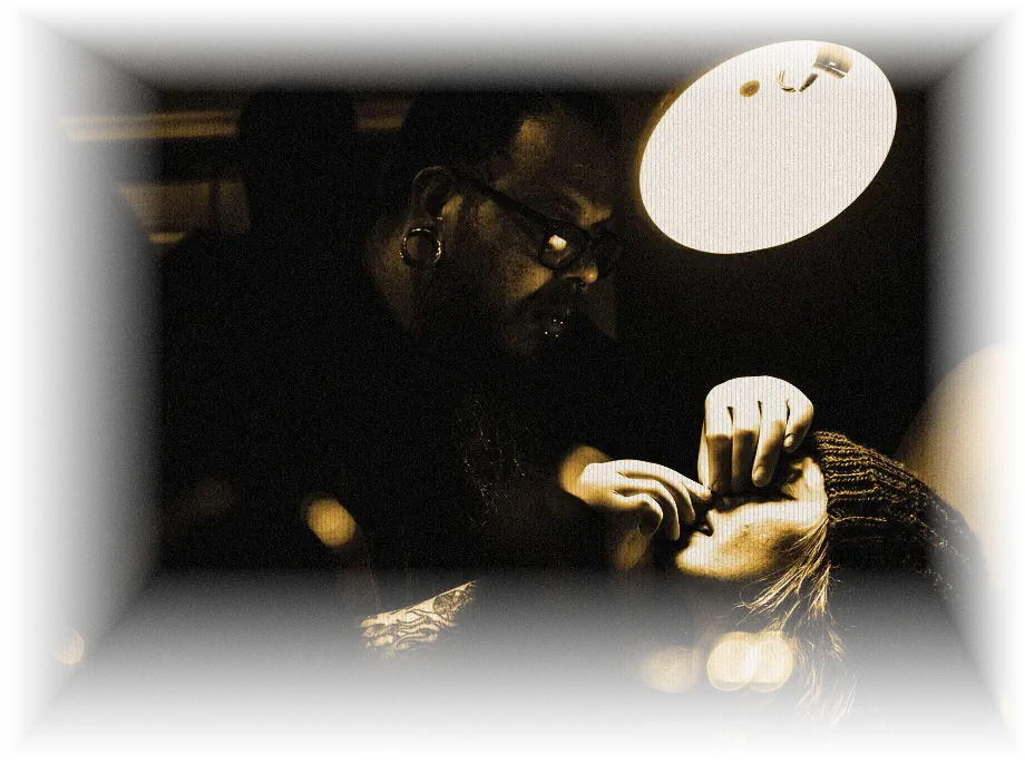 Body piercer working with a client